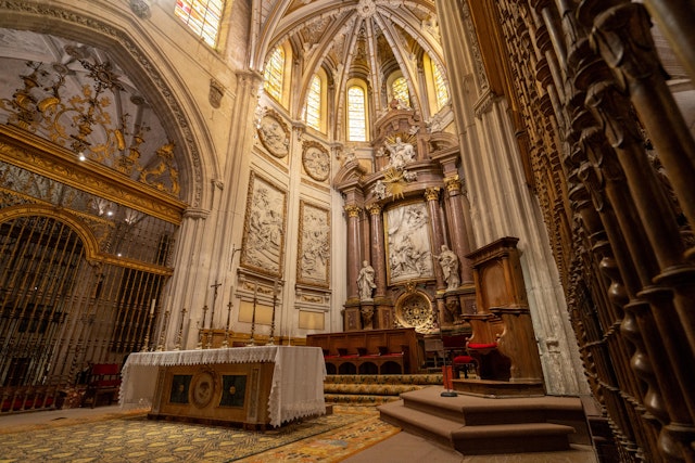 The cathedral's interior highlights Gothic vaulting, ornate altarpieces, and detailed stained glass windows.