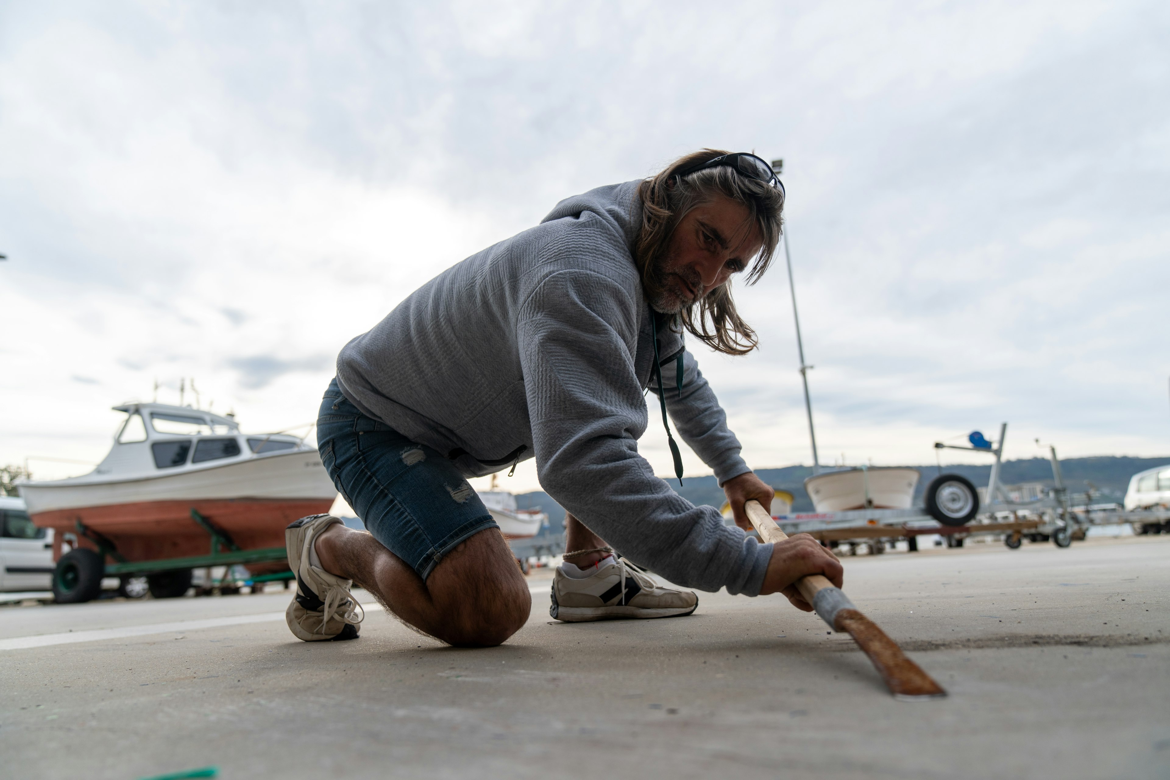 Roberto Vidal Pombo, a percebeiros, hones the blade of his scraper before setting out.