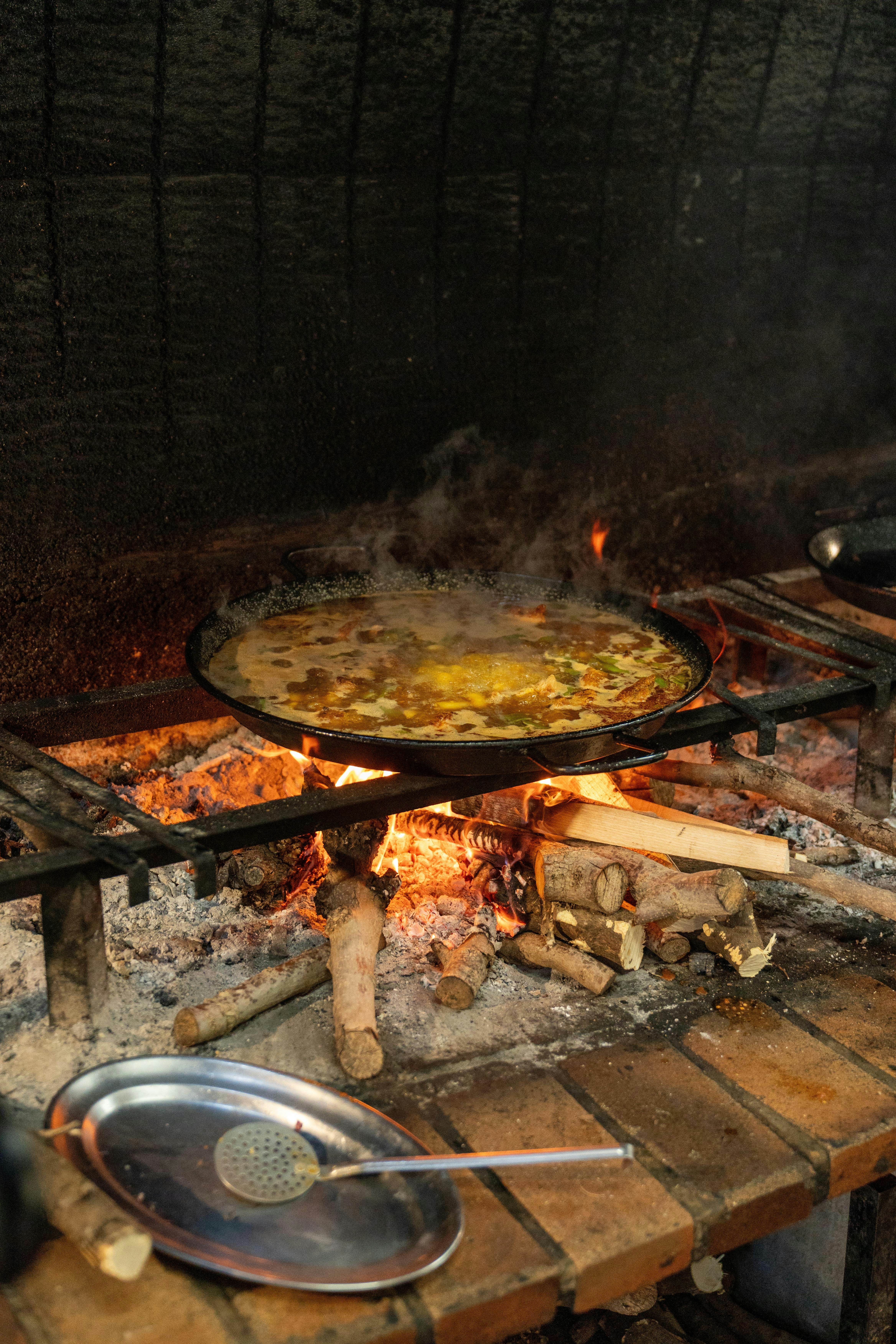 Paella is traditionally cooked over an open flame.