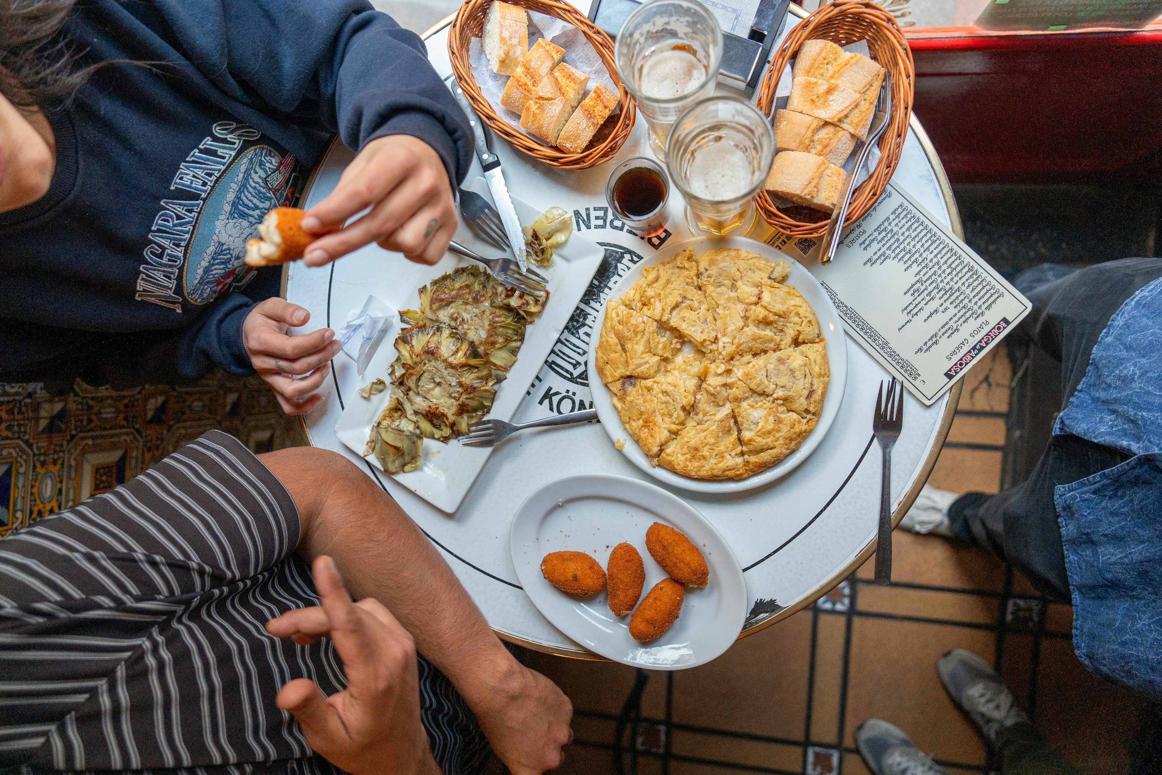 Food and drink in Spain is rooted in fresh, seasonal and often organic produce. Like these tapas and beer in Madrid.